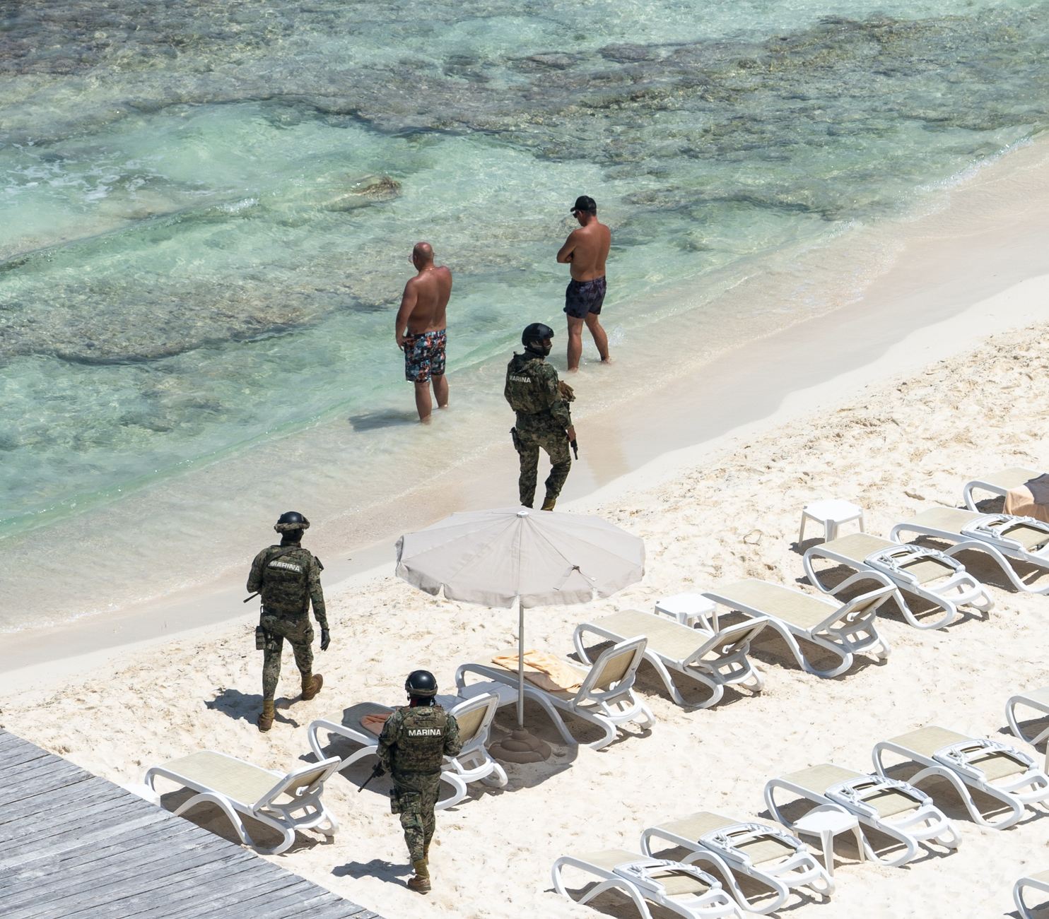 Policía de Cancún y militar en la playa