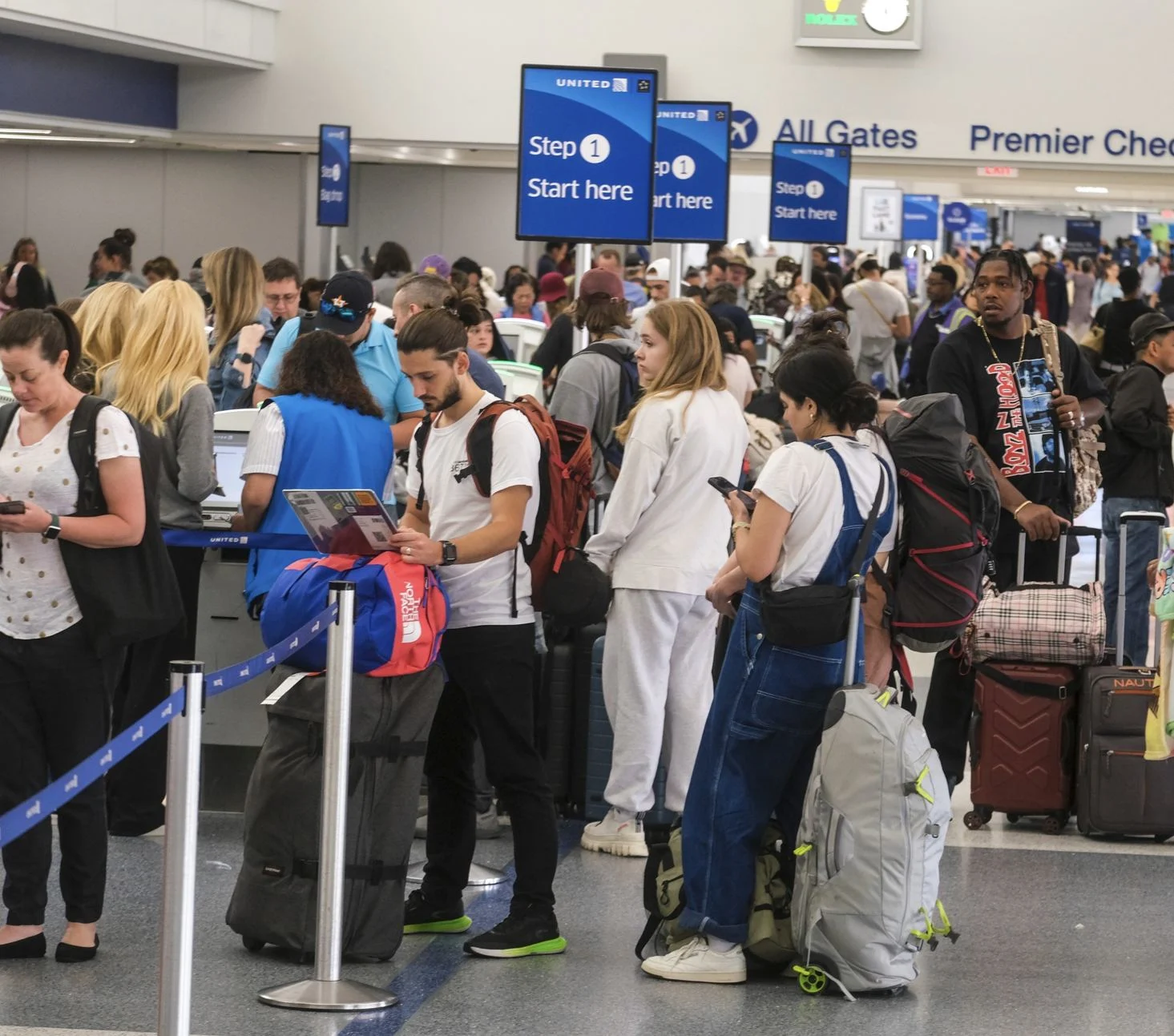 Pasajeros-espera en línea a un unito-check-in-counter.jpg