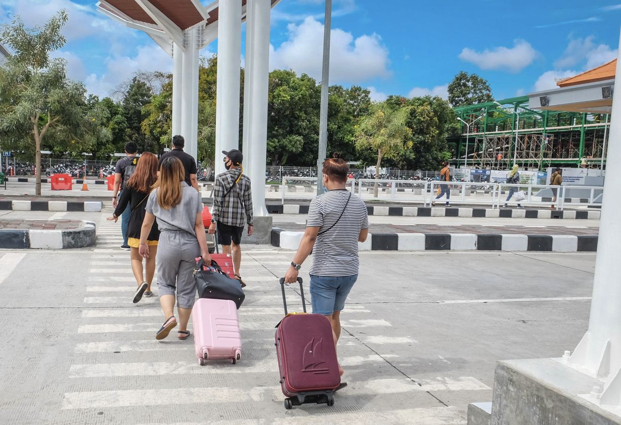 Viajeros que salen del aeropuerto con equipaje